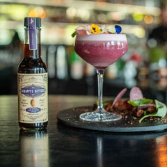Scrappy's Lavender being poured into a mixing glass for precise flavoring