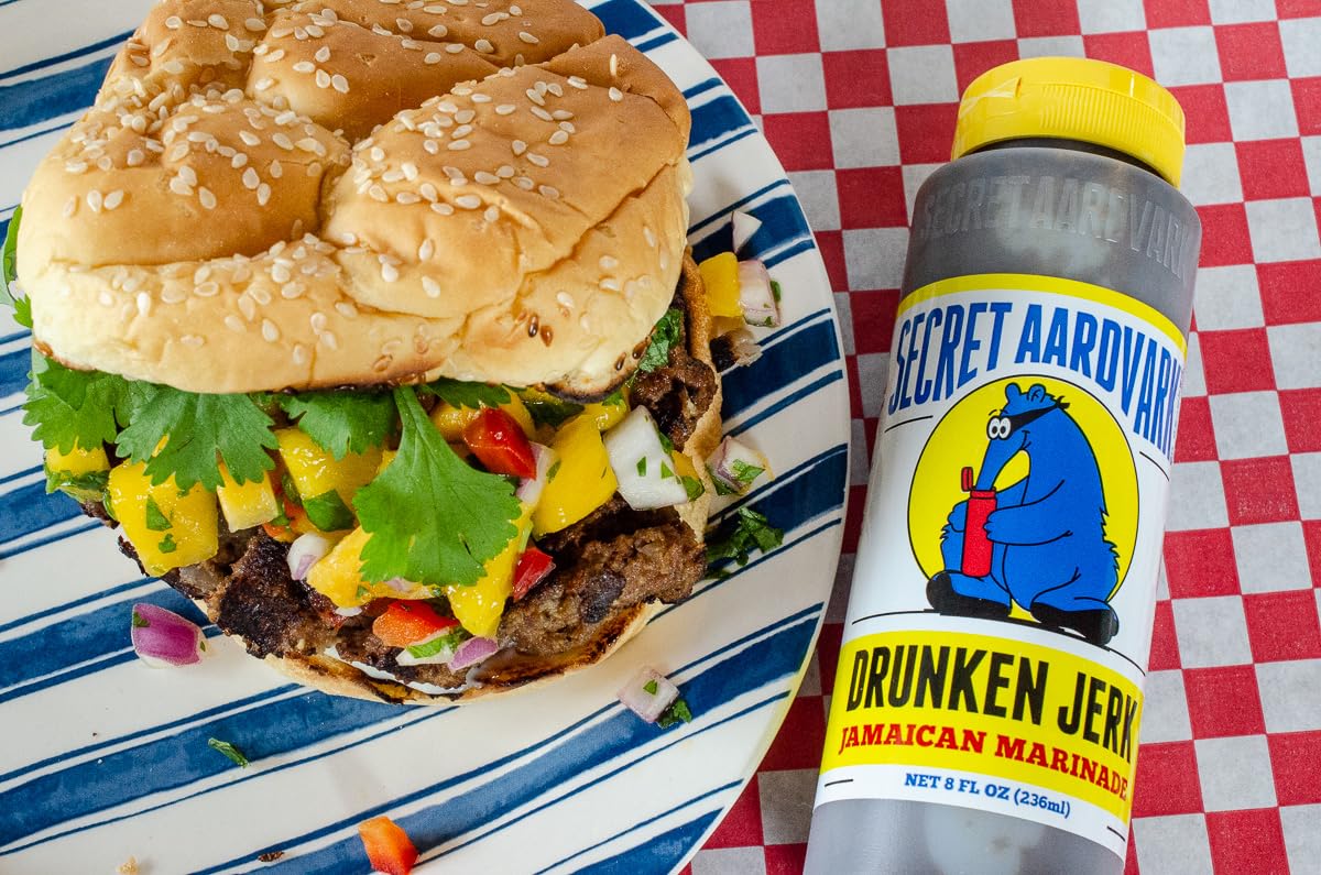 Secret Aardvark bottles next to a spoon to show 8 fl oz size scale