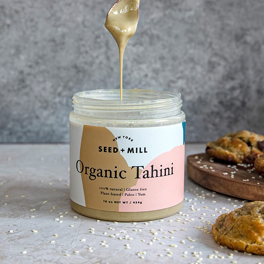 Seed + Mill open jar with spoon demonstrating creamy texture and easy serving