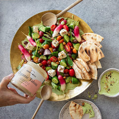 Seed + Mill tahini pouring to show smooth texture and mixing versatility benefit