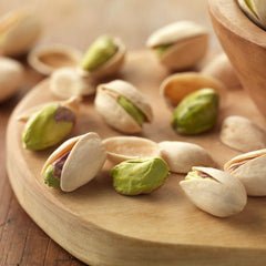 Setton Farms open burlap bag spilling pistachios demonstrating generous 14 oz contents