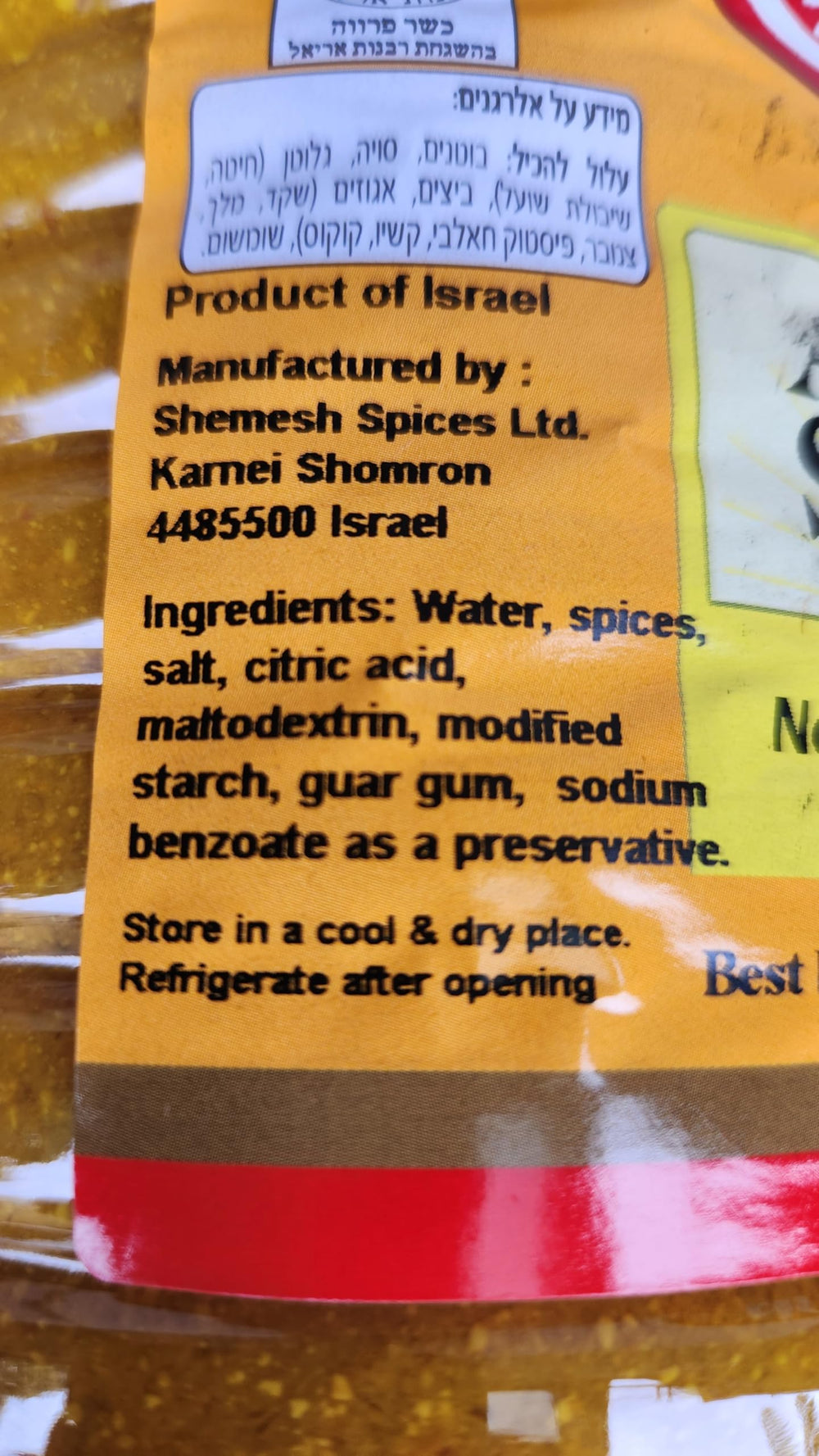 Close-up spoon of Shemesh Amba showing chunky mango texture for rich mouthfeel