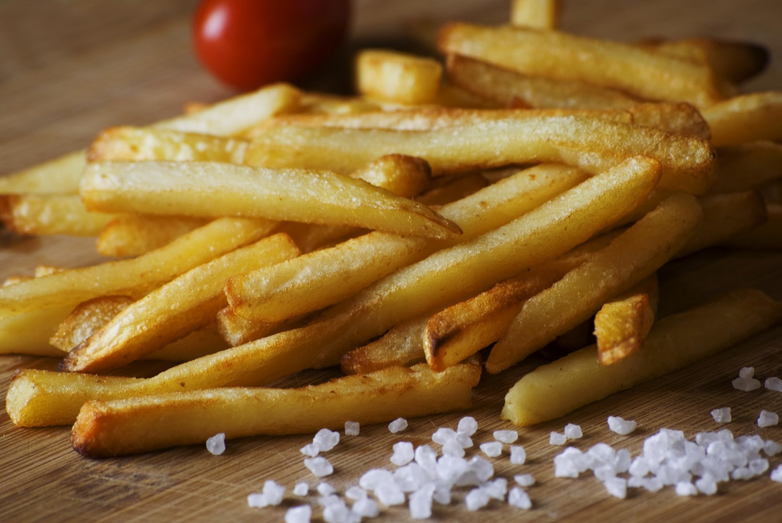 Hand tearing a Single Serv packet and sprinkling salt, precise portion control