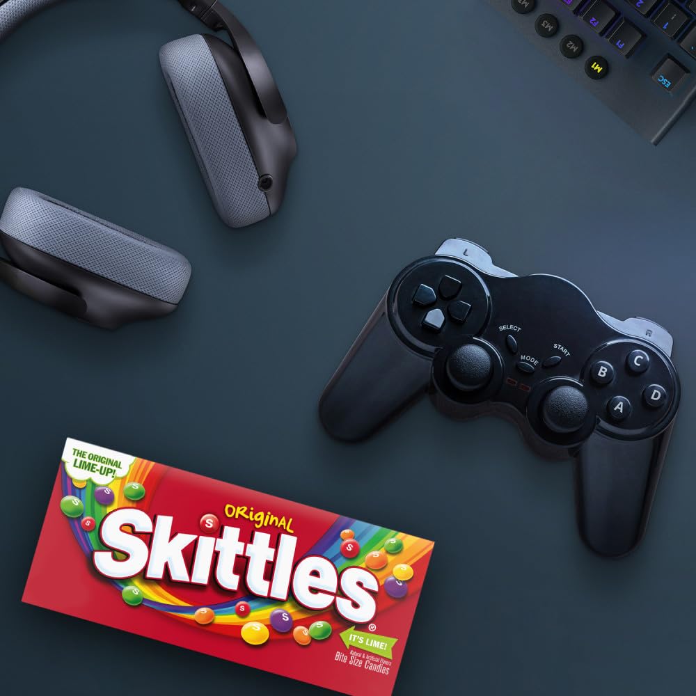 Skittles box beside smartphone for scale showing portable, pocketable size