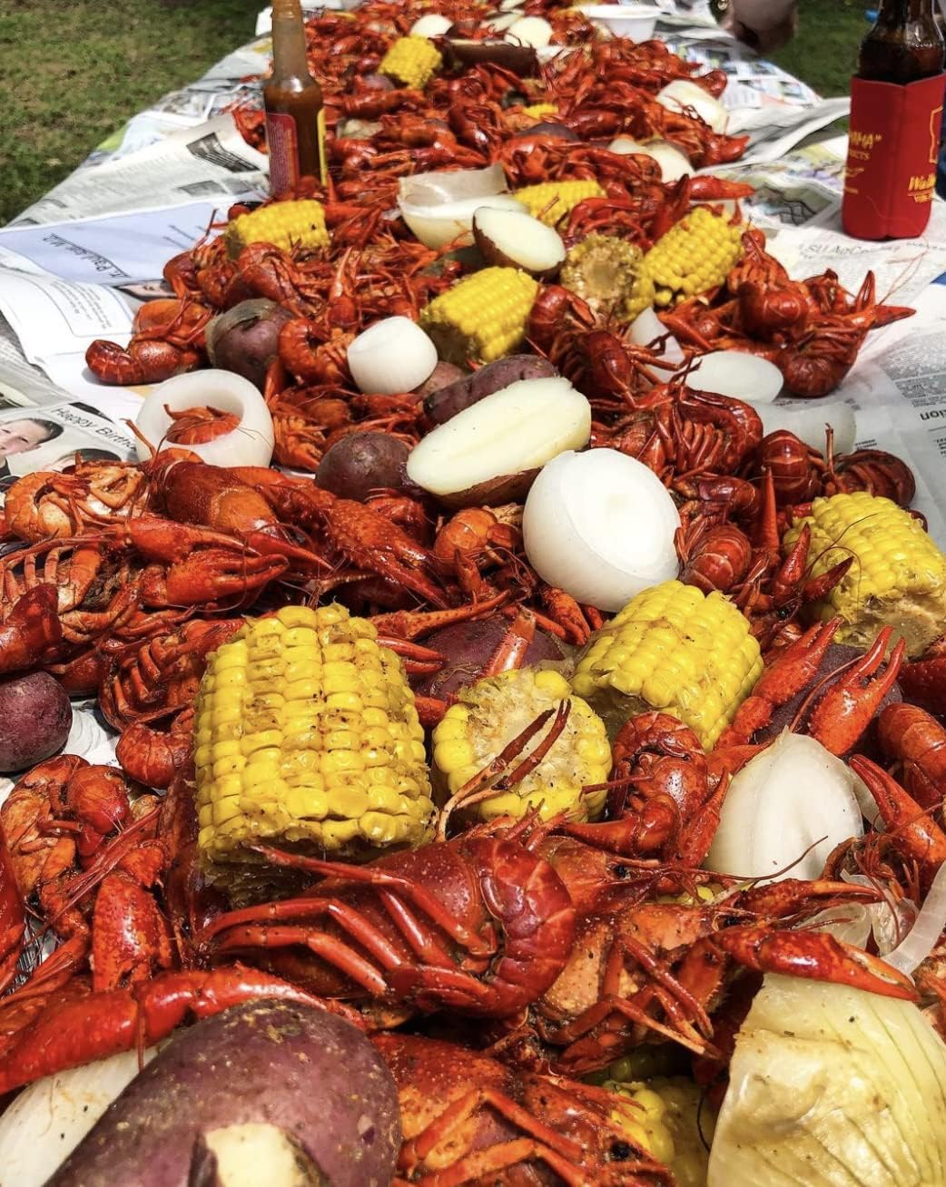 Slap Ya Mama seasoning dissolving in a large pot with seafood for an even, seasoned boil