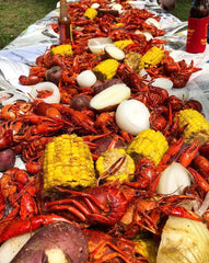 Slap Ya Mama seasoning dissolving in a large pot with seafood for an even, seasoned boil