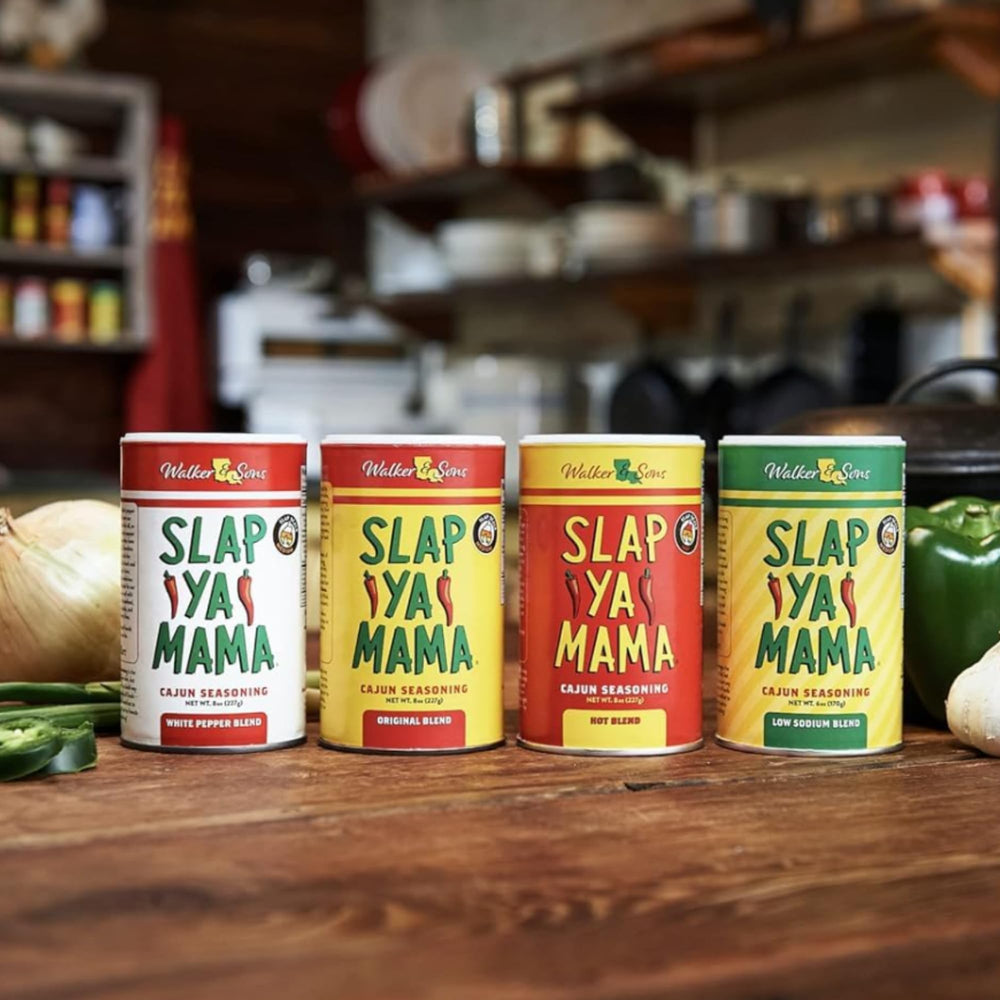 SLAP YA MAMA size comparison with hand holding canister to show 8 oz scale