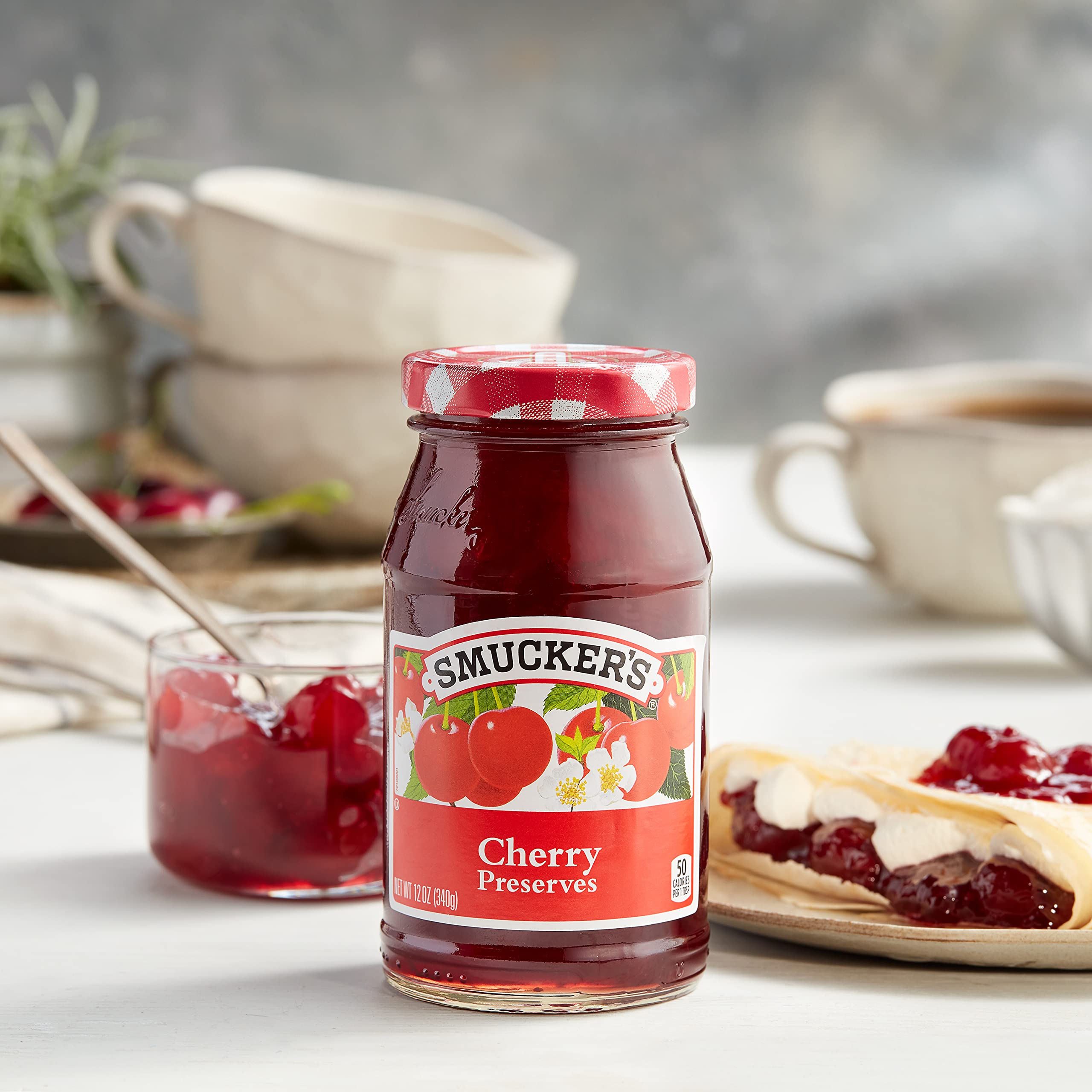 Smucker's spoon closeup with cherry pieces, showcases chunky texture and flavor