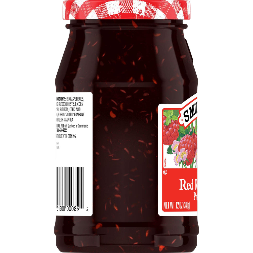 Smucker's jar close-up showing textured raspberry pieces and glossy preserve