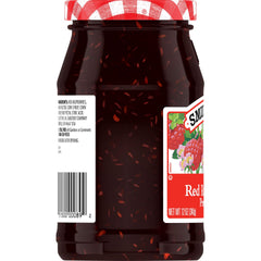 Smucker's jar close-up showing textured raspberry pieces and glossy preserve