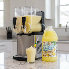 SNAPPY Frosti Tropics being poured into a slush machine reservoir, demonstrating easy mixing and setup