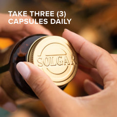 Solgar capsules in hand illustrating dosage size and practical portioning on the go