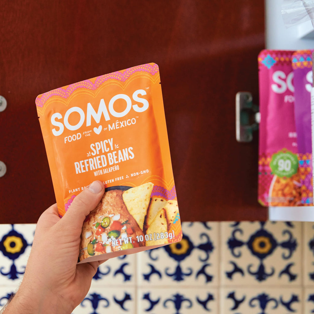 SOMOS containers on a camping picnic table, portable plant-based protein for outdoors