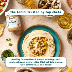 Soom tahini jar next to a bowl of hummus showing creamy finish and ease