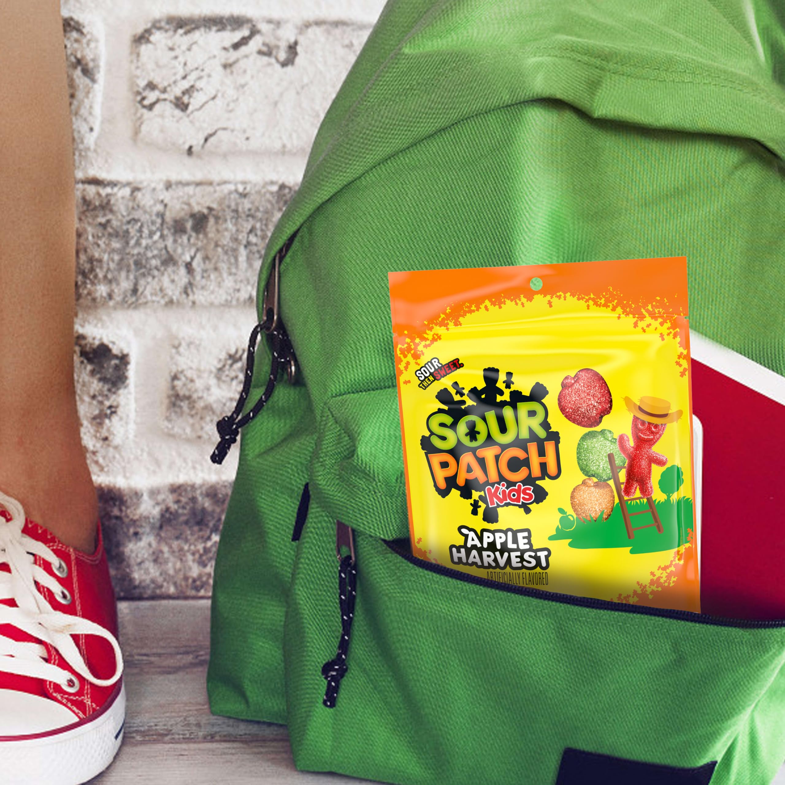 SOUR PATCH KIDS bag held in hand to show true size and portion friendliness