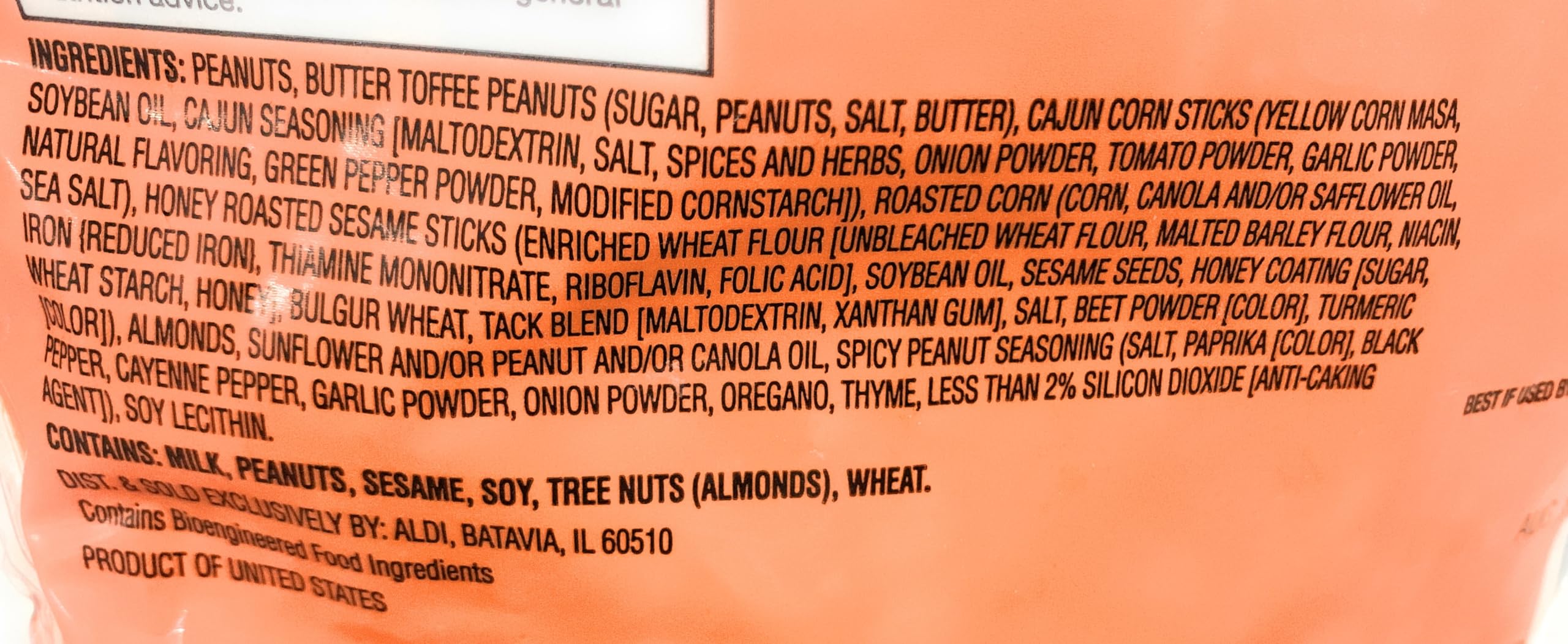 Southern Grove trail mix beside a measuring cup indicating portion size and portable convenience