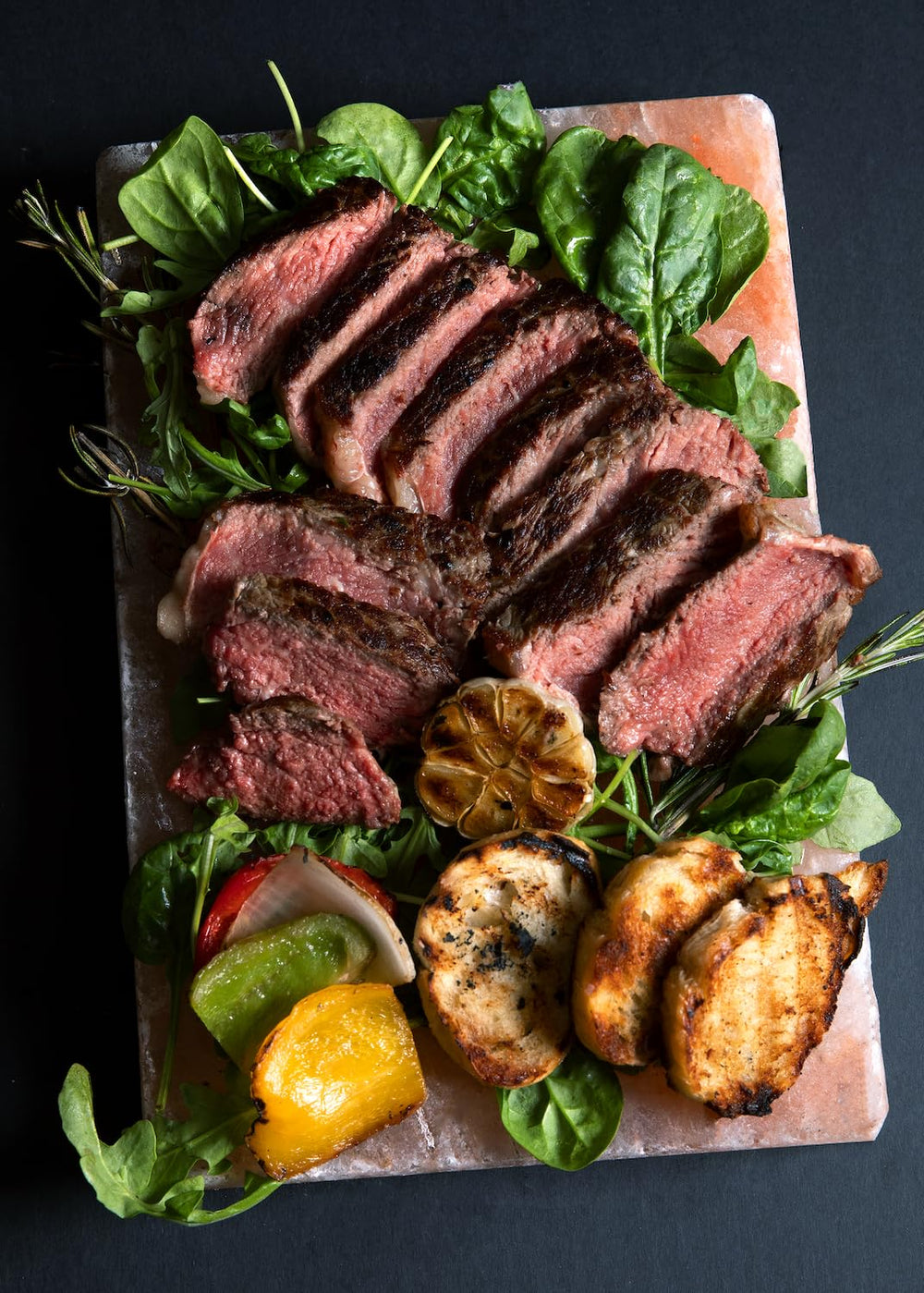 Spantik salt slab serving seared steak and vegetables, presents food attractively