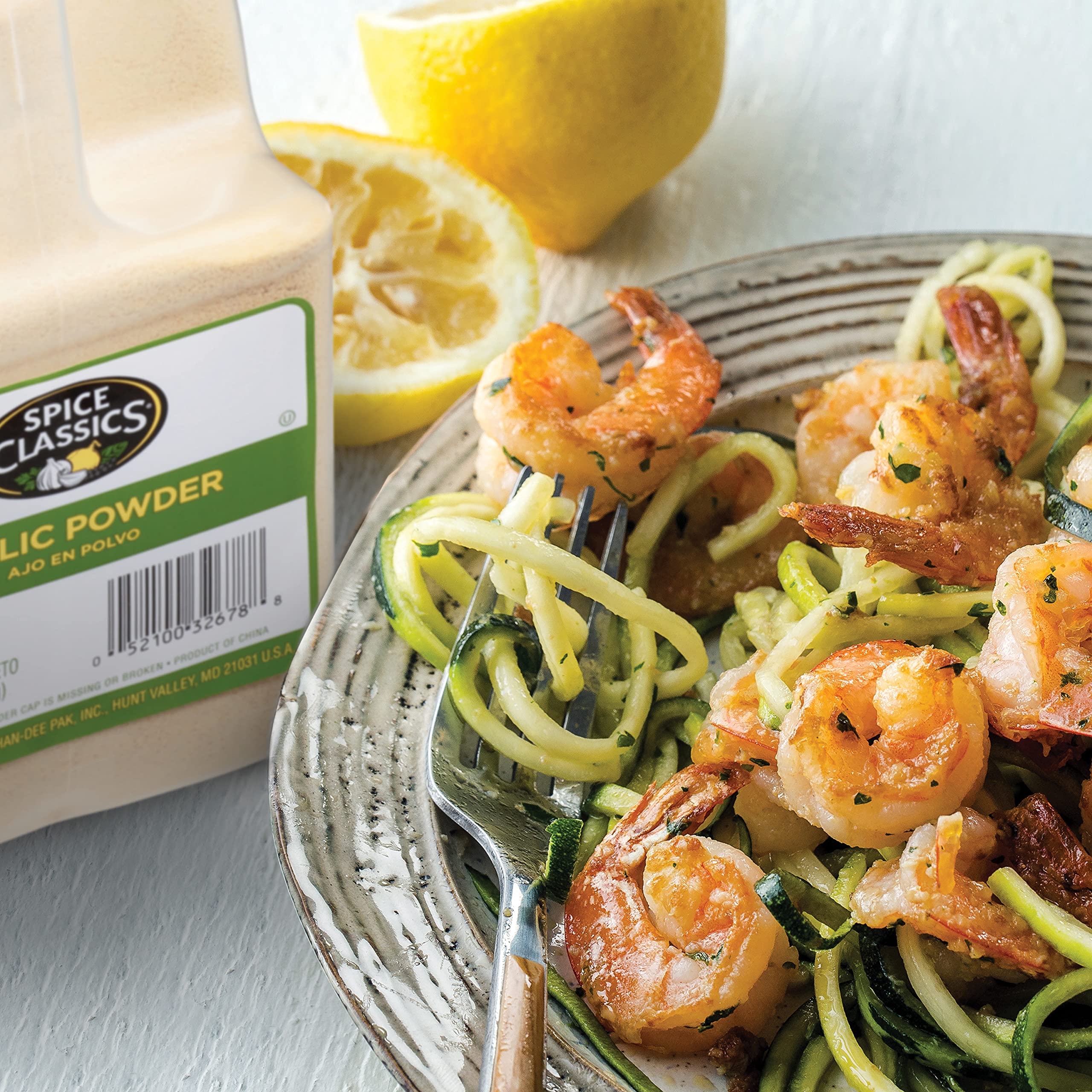 Spice Classics garlic powder rubbed onto meat to enhance savory grilling
