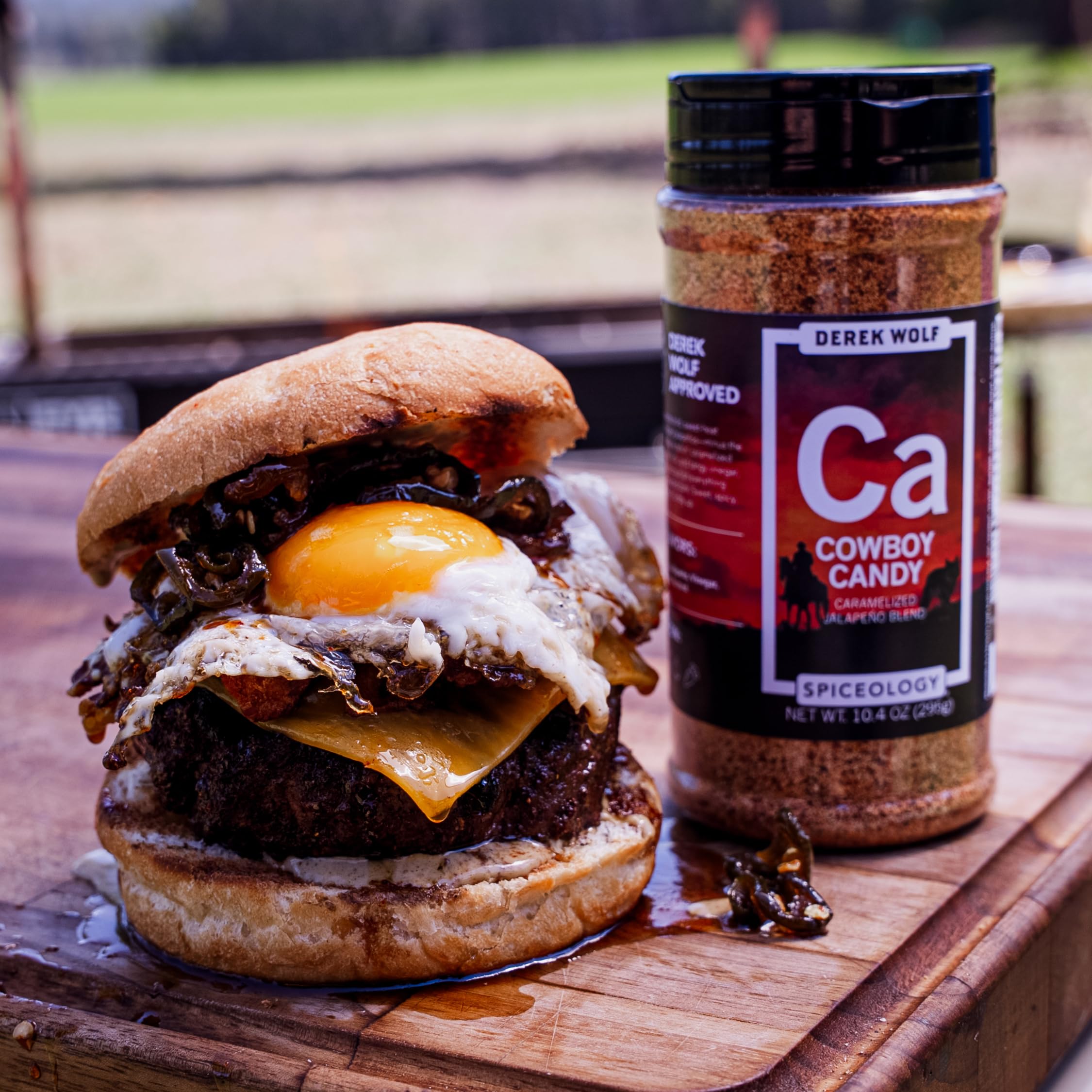 Spiceology Derek Wolf shaker near backyard grill suggesting smoky grilling enhancement