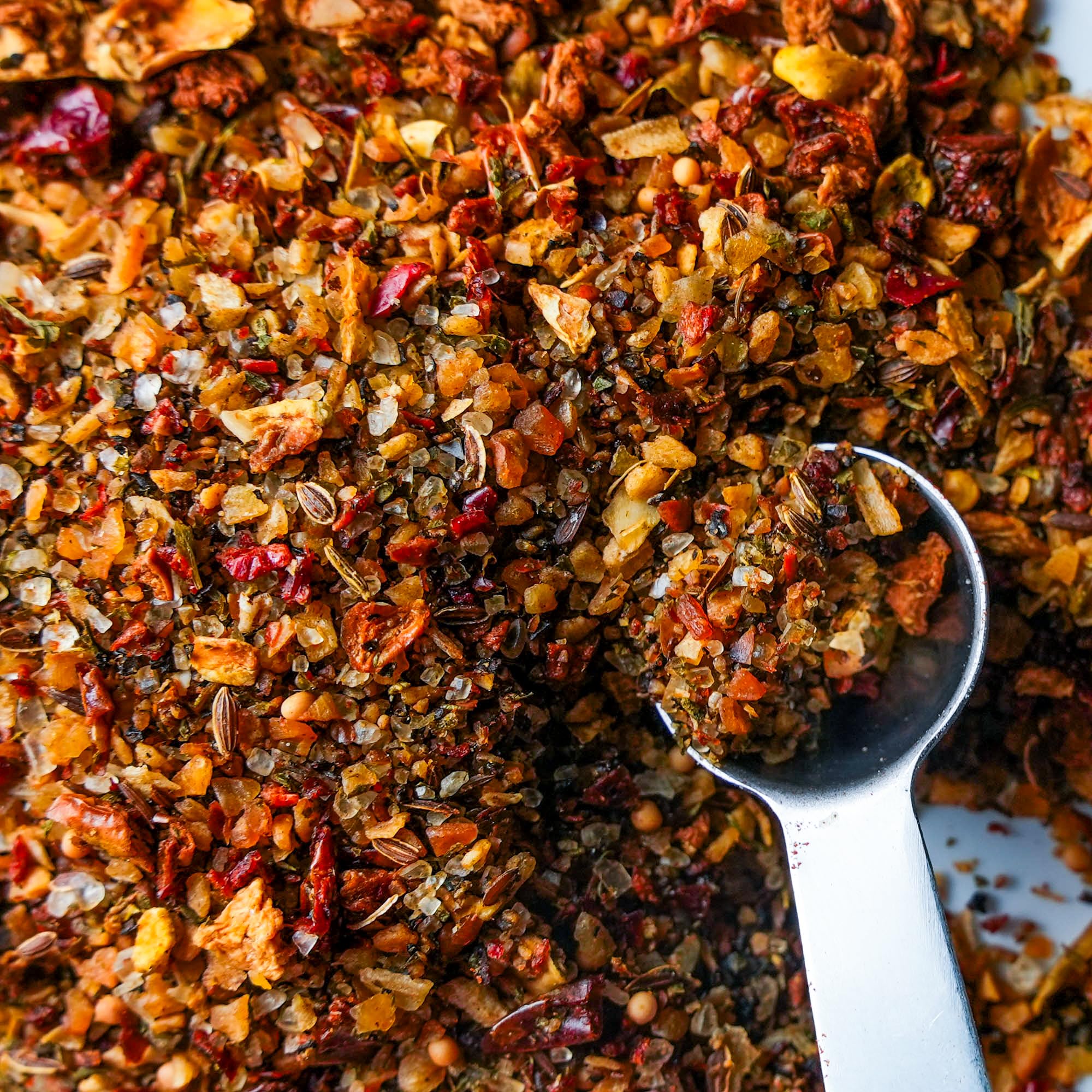 Spiceology Derek Wolf spoon with rub beside label showing ingredient clarity