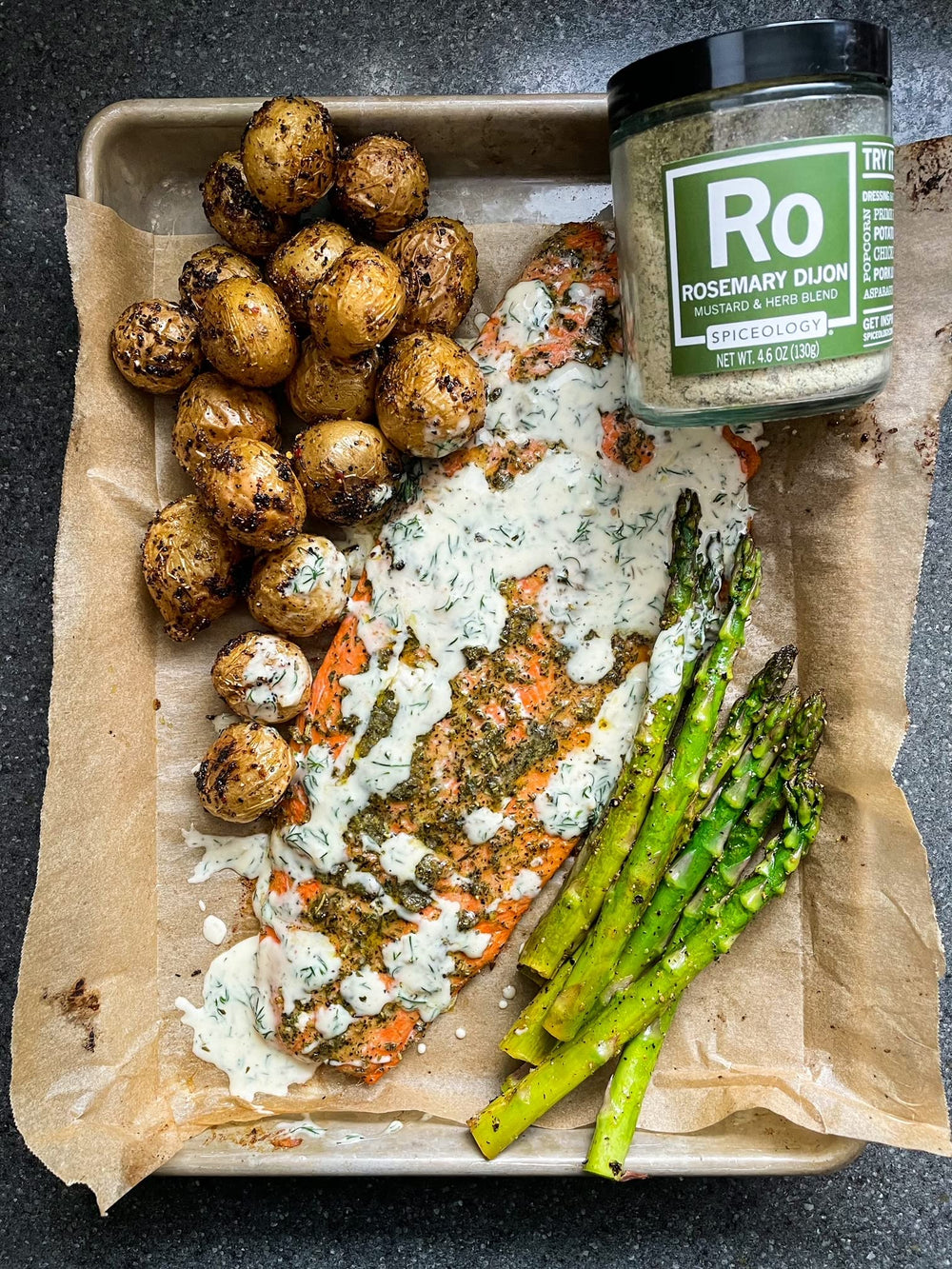 Kitchen counter scene with Spiceology rosemary Dijon used in everyday cooking