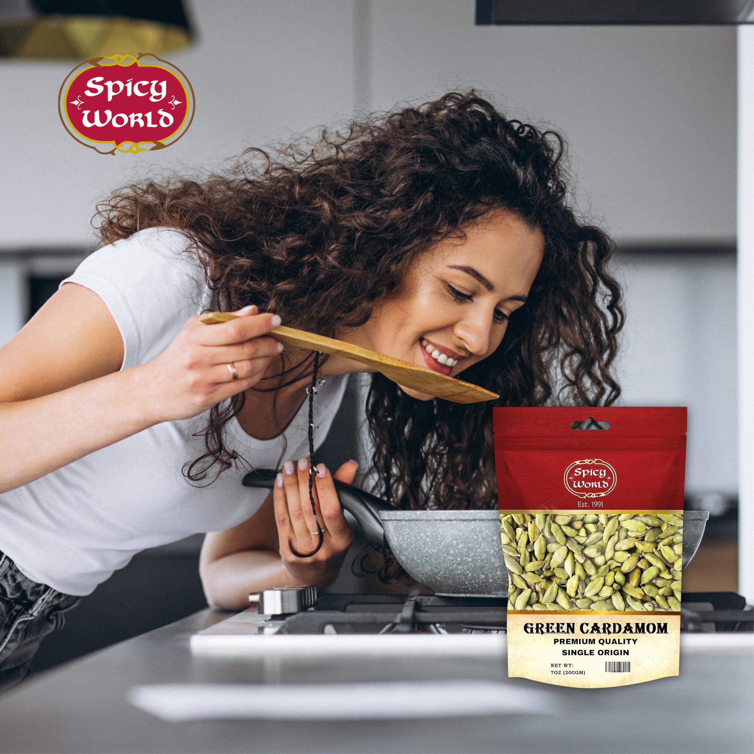 Spicy World cardamom in a bowl with a hand for size and portion reference