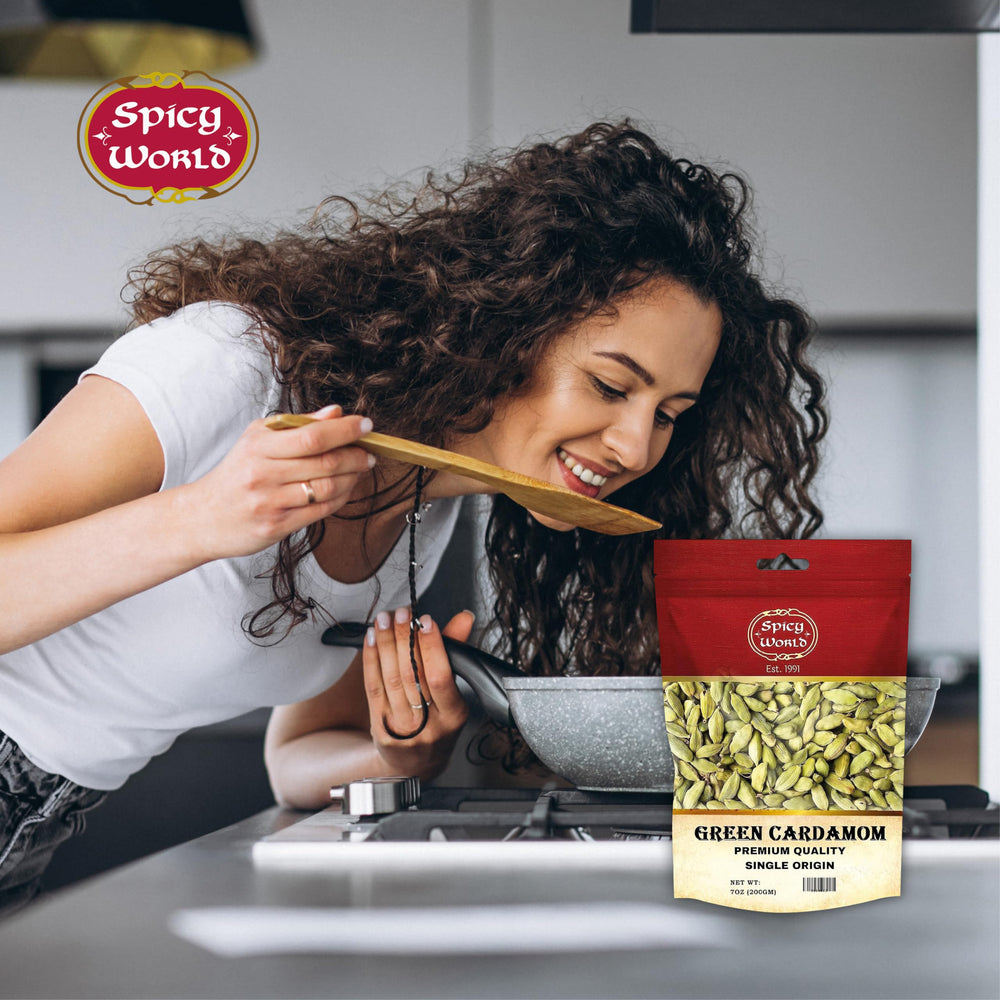 Spicy World cardamom in a bowl with a hand for size and portion reference