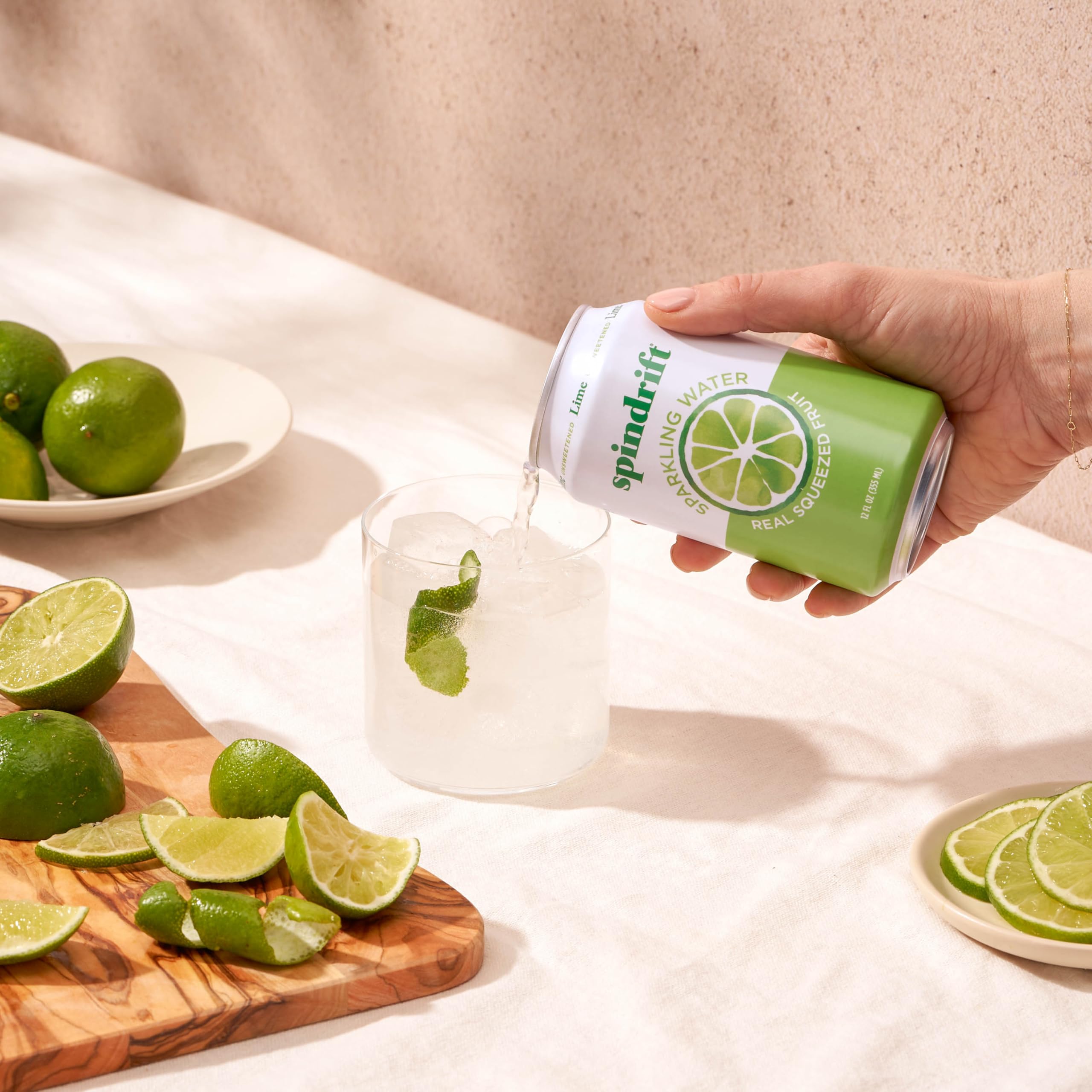 Spindrift lime can held in hand showing 12 oz scale for portability