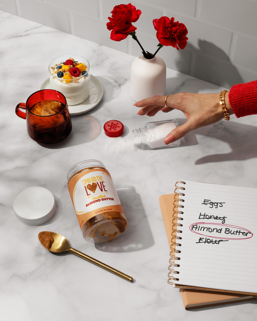 Spread The Love raw California almonds next to jar showing premium ingredient benefit