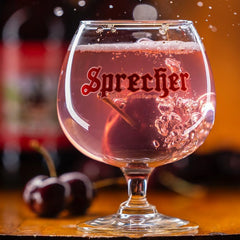 Glass being poured with Sprecher Cherry Cola showing crisp carbonation and refreshment
