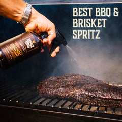 Spritz King bottle sitting beside a hot grill illustrating outdoor use convenience