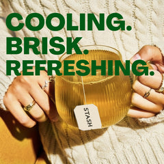 Poured peppermint tea in a clear cup by Stash showing vibrant color and refreshing quality