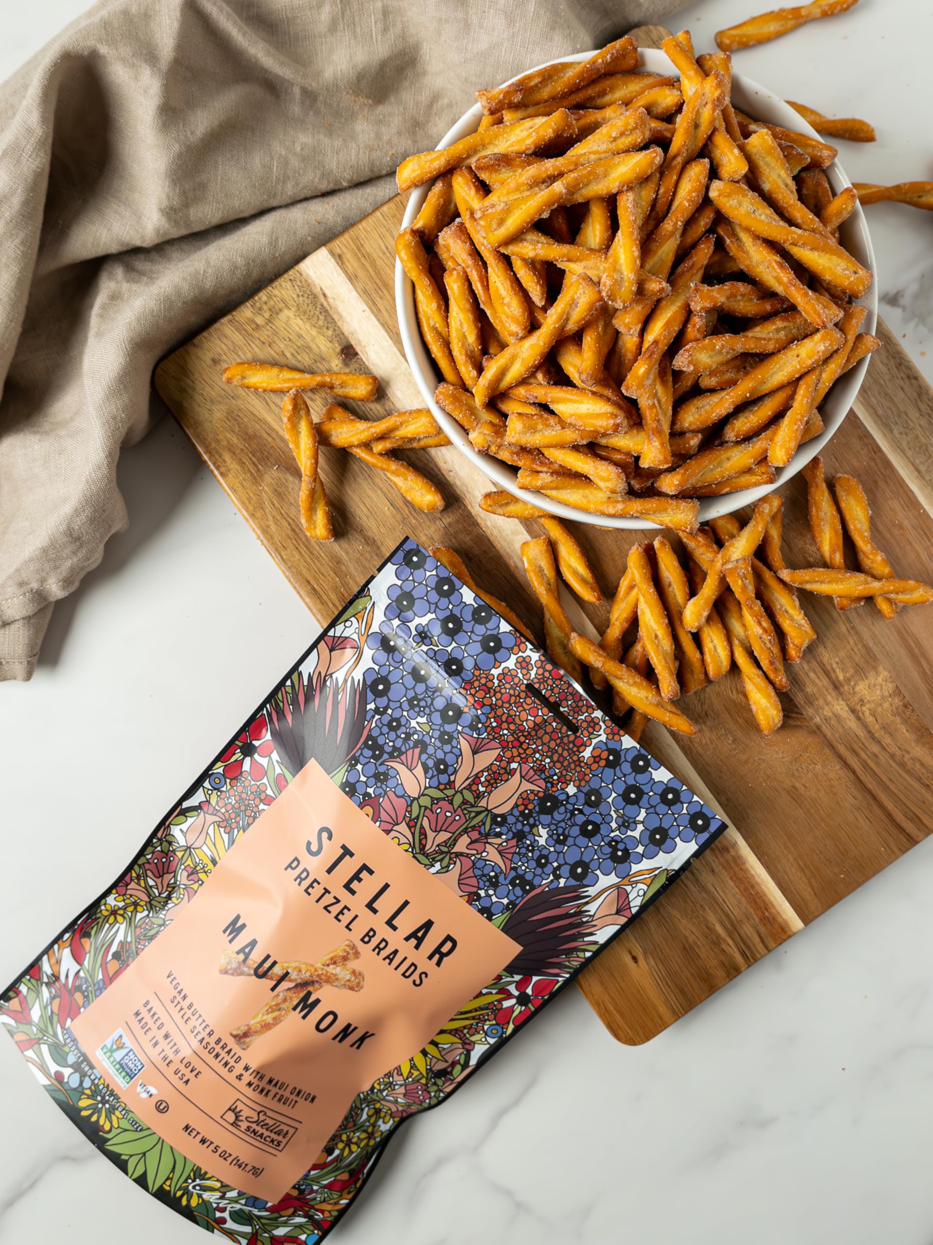 Pretzel braid dipped into hummus to illustrate Stellar Snacks pairing suggestions and savory appeal