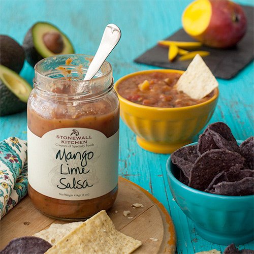 Stonewall Kitchen jar open with visible mango chunks, highlighting chunky texture