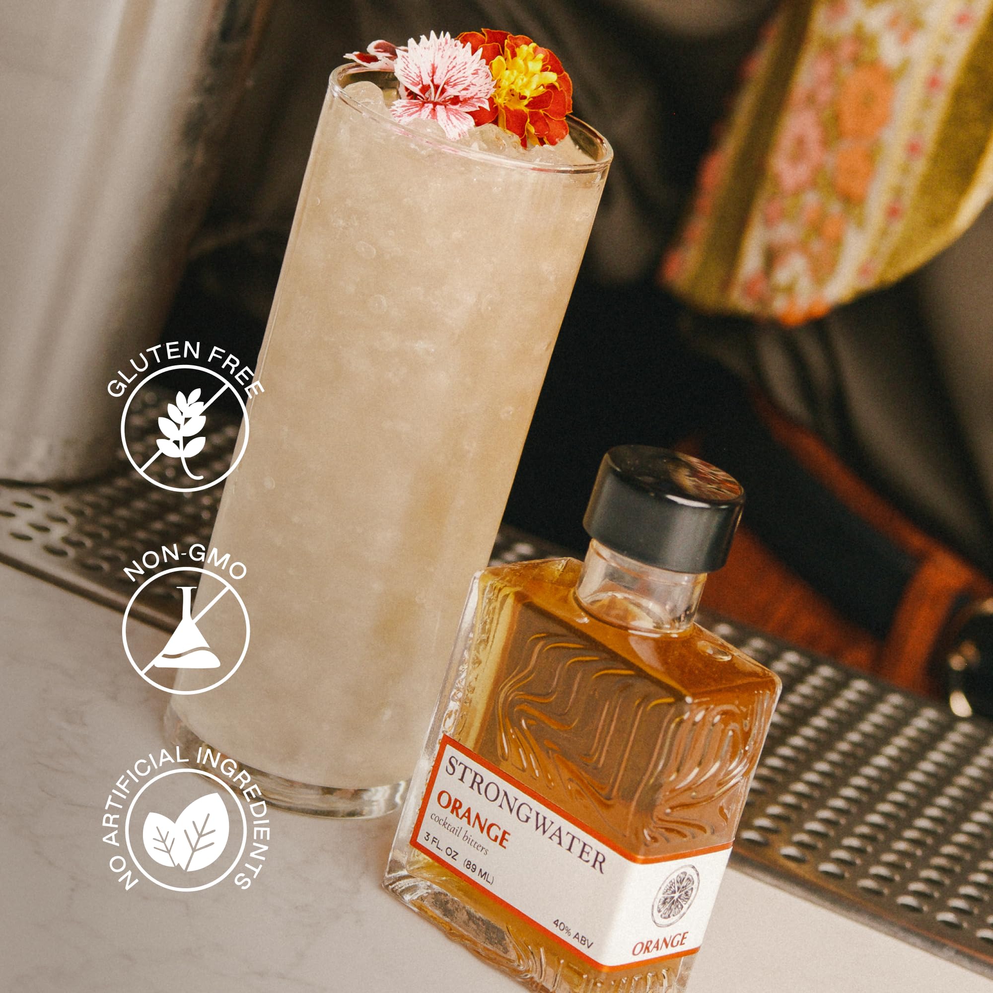 Pouring a dash into a glass, Strongwater bitters adds balanced orange depth