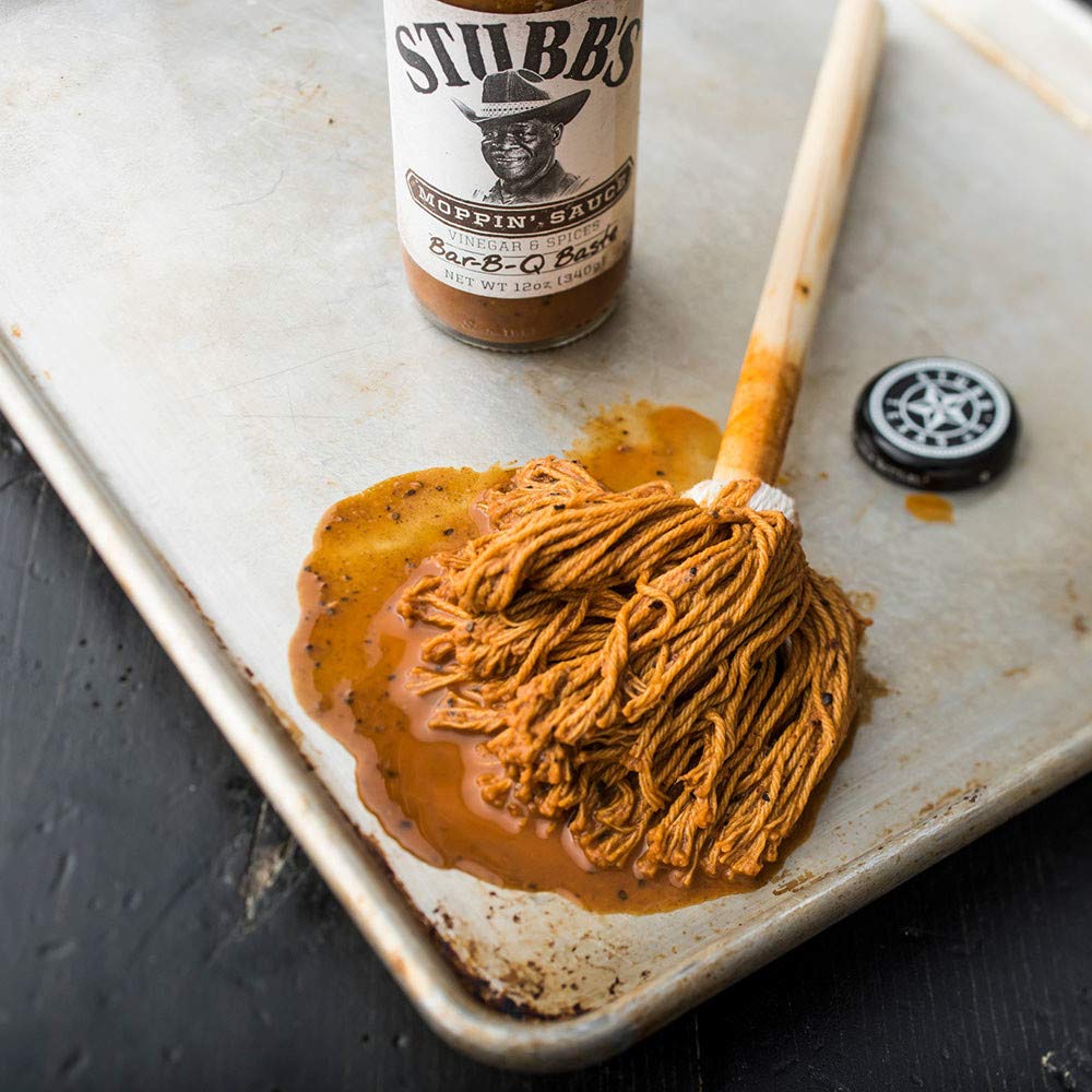 12 oz Stubb's moppin' sauce bottle beside a hand for scale and portion control