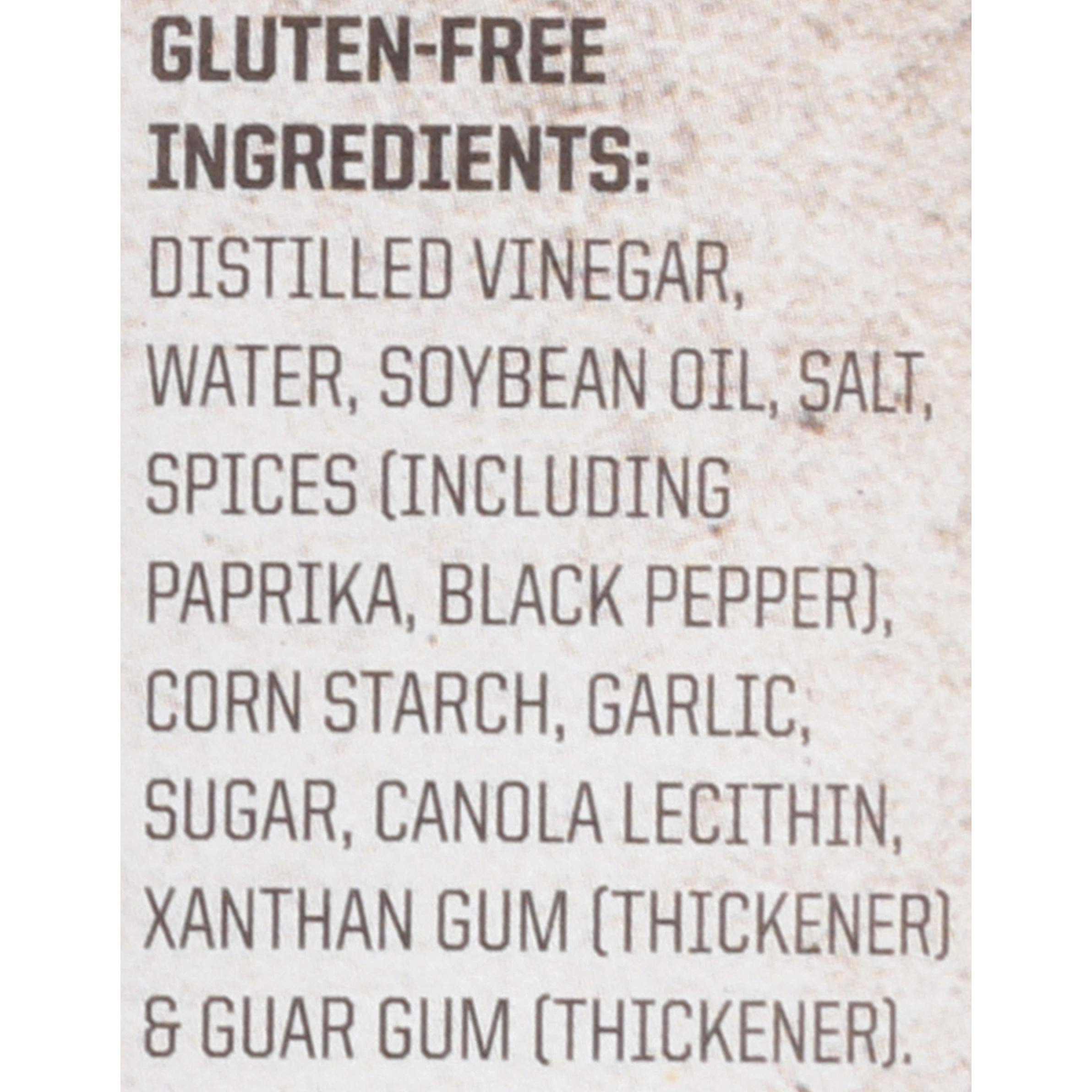 Arrangement of Stubb's moppin' sauce with spices showing flavor profile benefit