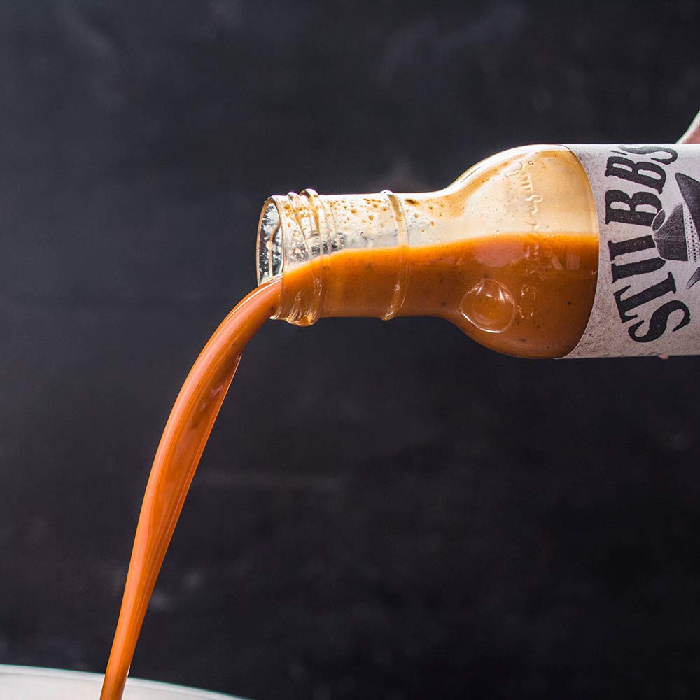 Pouring Stubb's moppin' sauce to show thin texture for easy application benefit