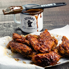 Stubb's being poured over ribs creating a sticky caramelized finish