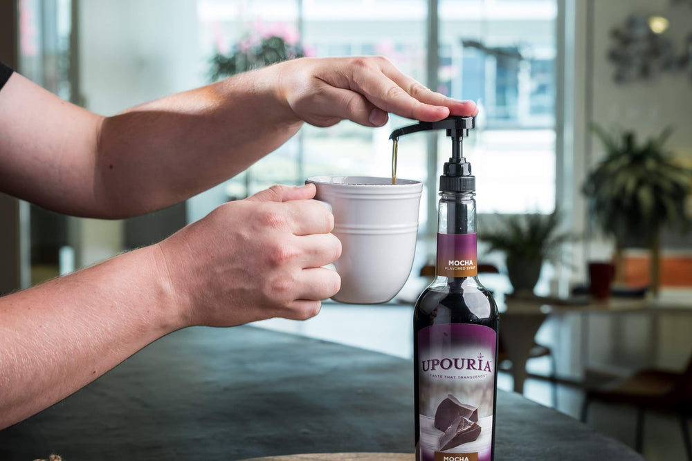 Sunny Sky Upouria syrup pouring into a coffee cup delivering rich mocha flavor