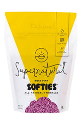 Supernatural front packaging showing rosy pink softies and clear jar, highlights clean ingredients