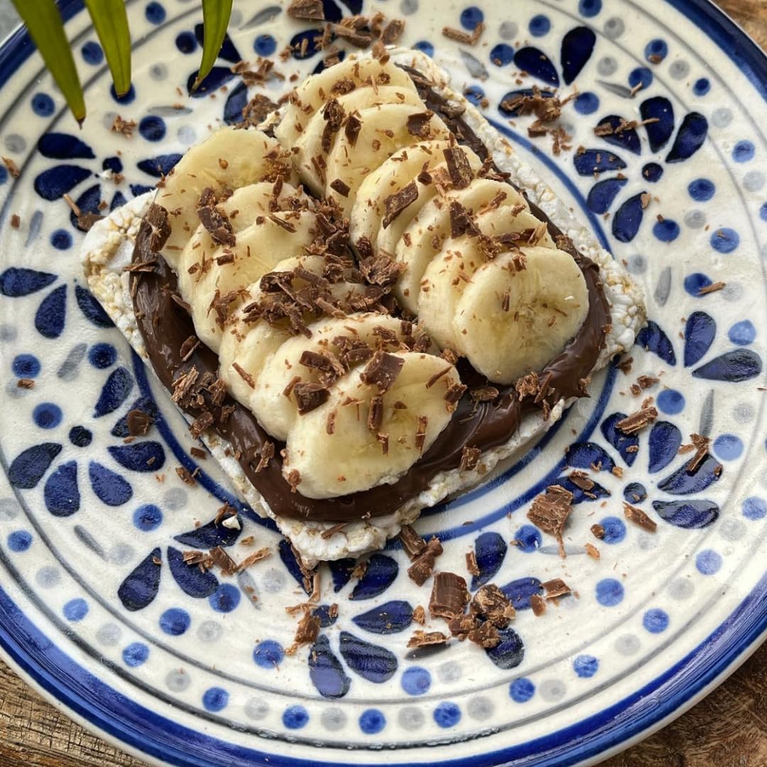 SUZIE'S corn cake thins topped with cheese and hummus for a low-calorie snack