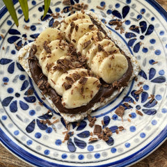 SUZIE'S corn cake thins topped with cheese and hummus for a low-calorie snack