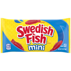 Hand holding Swedish Fish mini beside coin showing snack-sized scale
