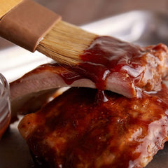 Sweet Baby Ray's cup used for dipping chicken finger, enhancing flavor and presentation