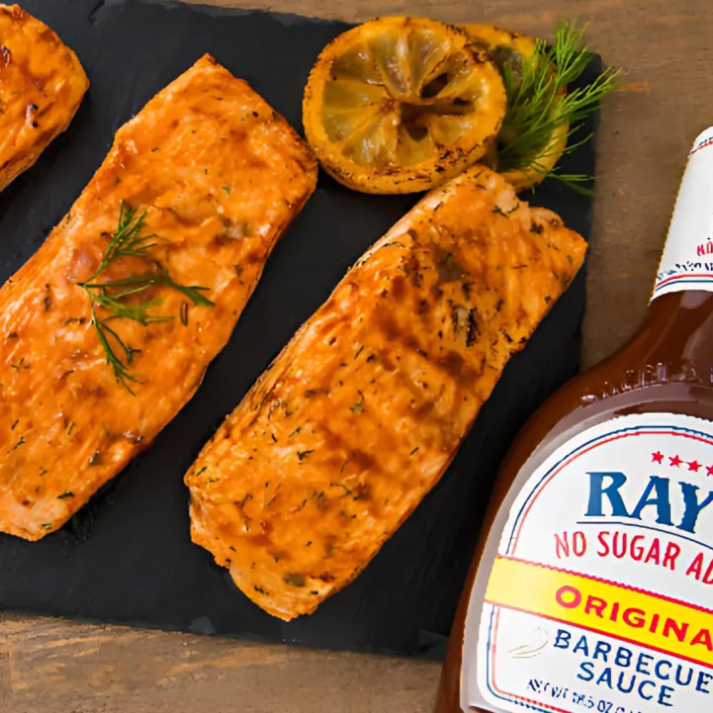 Sweet Baby Ray's sauces on a grill-top spread showing variety pack usefulness for entertaining