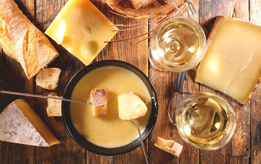 Hand dipping bread into Swiss Knight fondue demonstrating easy pairing benefit