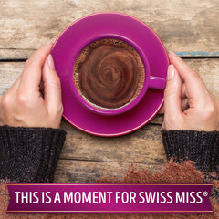 Swiss Miss hot cocoa in a mug with steam, showing comforting warmth benefit