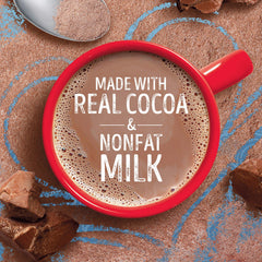 mug of Swiss Miss hot cocoa in hand showing comforting, warm enjoyment