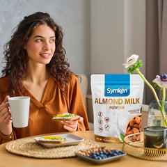 glass of reconstituted SYMKEN almond milk, creamy dairy-free drink benefit
